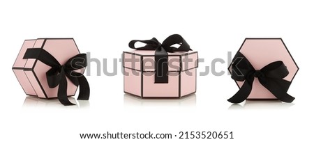 Pink pastel empty gift box with black ribbon isolated on white background