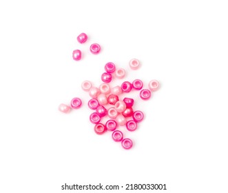 Pink pearly beads isolated. Beading craft set, bead pile, beadwork handicraft elements on white backgrond