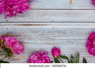 Pink peonies on blue wooden table