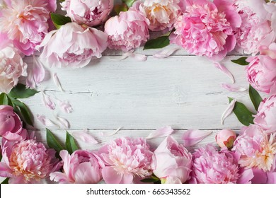 Pink peonies on a wooden background