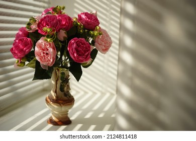 Pink Peony Flowers In Vase On Sunny Windowsill.