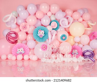 pink photo background with pastel balloons and owl decorations, and neon birthday theme sign