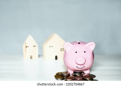 Pink Pig Piggy Bank On A Pile The Coin Is Placed On A Wooden Counter. Concept For Finance, Banking, Savings, Interest, Business, Loan, Tax. Closeup, Copy Space On Top For Design, Blurred Background.