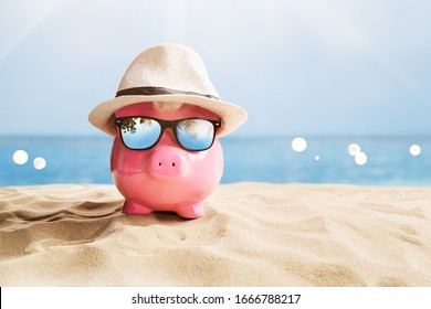 Pink Piggy Bank With Black Sunglasses On Beach - Powered by Shutterstock