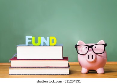 Pink Piggy Bank With Chalkboard In The Background As Concept Of Funding Education