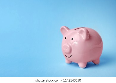 Pink piggy bank on color background. Money saving