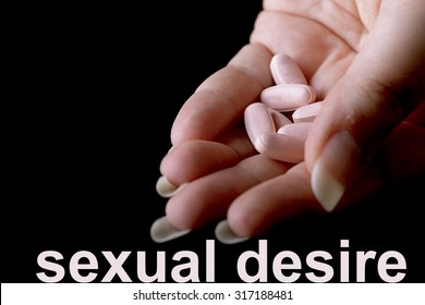 Pink Pills Under Female Hand For Female Viagra