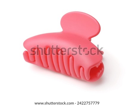 Pink plastic claw hair clip isolated on white
