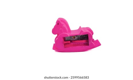Pink plastic pencil sharpener in the shape of a rocking horse, with a white background