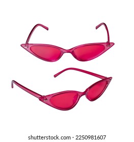 Pink plastic sunglasses in the shape of a cat's eye, black lenses isolated on a white background with a cut-off track. Stylish retro sunglasses.