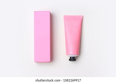 Pink Plastic Tube And Box On White Background. The View From The Top