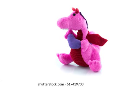 Pink plush dragon doll holding the purple heart shape isolated on white