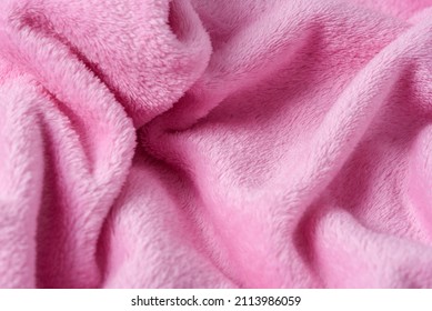 pink plush plaid background with folds, fluffy texture,
