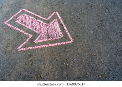 Pink pointer on the asphalt