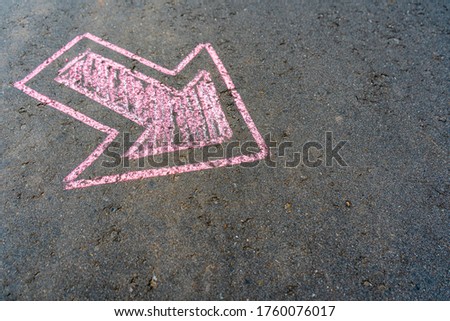 Pink pointer on the asphalt