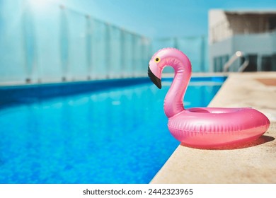 Pink pool float flamingo by blue water, pool party toy. Inflatable Swimming Ring. Summer vacation holiday luxurious resort. - Powered by Shutterstock