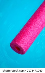 Pink Pool Noodle Floating On The Blue Water