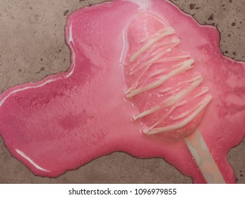 Pink Popsicle Ice Pop Melting on The Cement Floor on Summer time