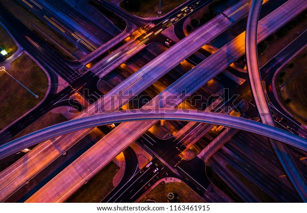 Pink and purple nightscape night driving city at\
night - Highway interstate 35 overpass and interchange\
transportation driving