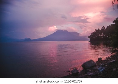 Pink And Purple Sunset With Views Of A Volcano Out On Lake Atitlán, Guatemala