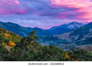 Pink purple sunset in Woody Creek in Aspen, Colorado with Rocky mountains of Buttermilk ski slope mountain in autumn and oak trees foliage