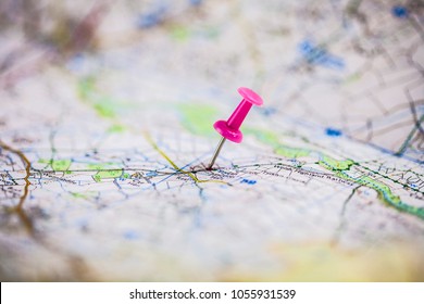 Pink pushpin showing the location of a destination point on a map