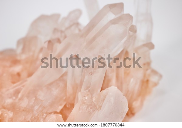 Pink quartz\
cluster crystal on white background\
