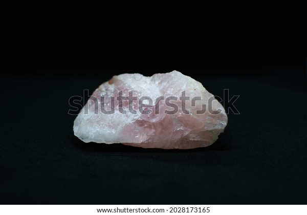 pink quartz stone on\
black background 