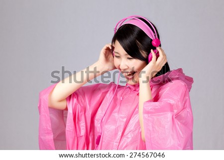 pink rain coat woman listening music