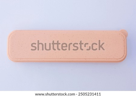 A pink rectangular box. This box can be used to store cutlery, stationery, etc.