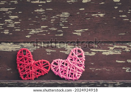 Pink and red heart with love put on the wood vintage in public park, for supporting when people get who lack of desire with love concept.