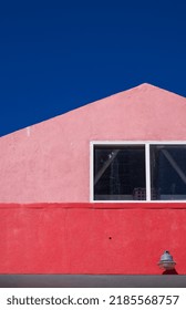 Pink And Red Loft Apartment With Blue Sky Above.