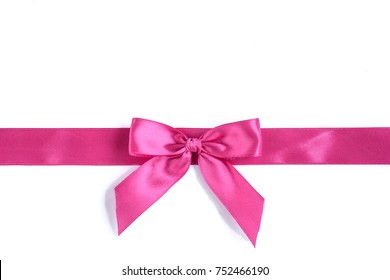 Pink ribbon and bow isolated on white background.
