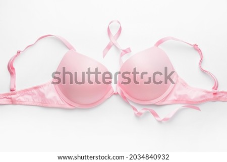 Pink ribbon and bra on white background. Breast cancer awareness concept