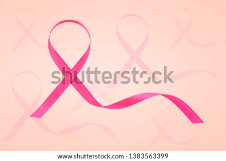 Pink ribbon. Breast cancer awareness symbol. Over pink background.