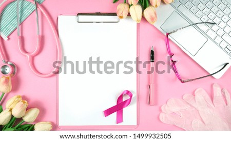 Pink Ribbon Breast Cancer Awareness concept with female pink doctors desk concept.