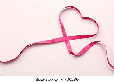 Pink Ribbon Heart On White Background.