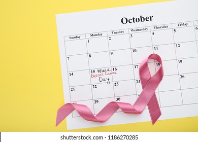 Pink Ribbon With October Calendar On Yellow Background. Breast Cancer Concept