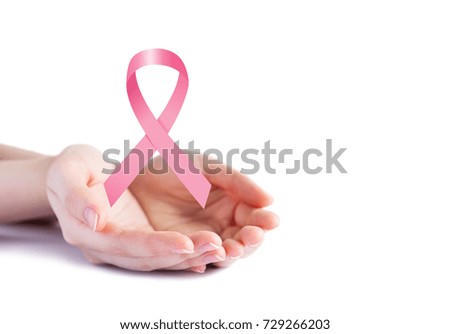 Pink ribbon on hands for breast cancer awareness on white background