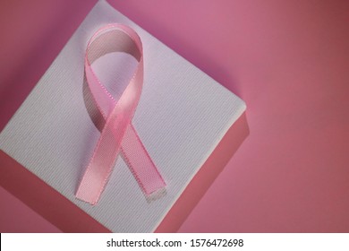 Pink Ribbon On A Pink And White Background. Ribbon In Tribute To Breast Cancer Patients.