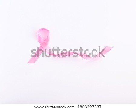Pink ribbon on a white background. International symbol of breast cancer awareness month in October. Women's health. Copy space