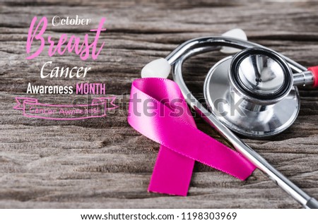 Pink ribbon and stethoscope on wooden background for supporting breast cancer awareness month campaign.