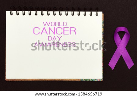 Pink ribbon for text World Cancer Day Awareness, symbolic bow color raising awareness on people living with women's breast tumor illness. bow isolated with clipping glitter blue background