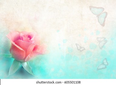 Pink rose and butterflies in front of a background of vintage old paper with a soft focus. Retro greeting for text and background .