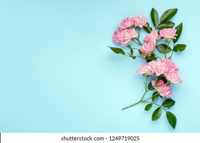 Pink Rose Flowers On Blue Background. Framework, Flower Composition. Flat Lay. Top View. Copy Space.