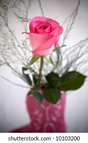 A pink rose in a little cowgirl boot.
