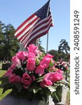 Pink Roses and American Flag on Grave at Rose Hill Cemetery in Tyler TX