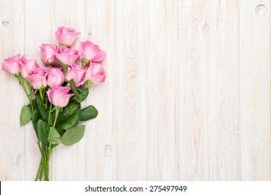 Pink Roses Bouquet Over Wooden Table. Top View With Copy Space