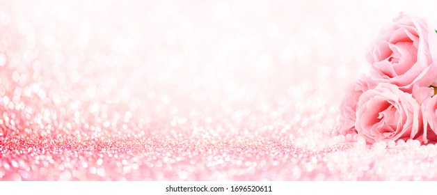Pink roses bouquet and pearls on abstract blur pastel background. Wedding flowers and bright bokeh glitter backdrop. Wedding, bridal, valentines and mothers day celebration design.