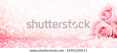Pink roses bouquet and pearls on abstract blur pastel background. Wedding flowers and bright bokeh glitter backdrop. Wedding, bridal, valentines and mothers day celebration design.